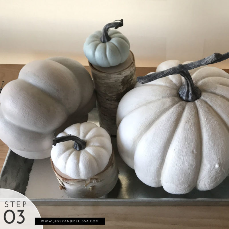 Step 3: Place the medium pumpkins on the birch pillars